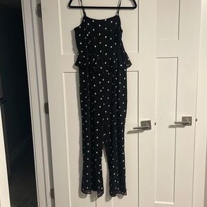 Anthropologie peplum jumpsuit with white flower stitching.